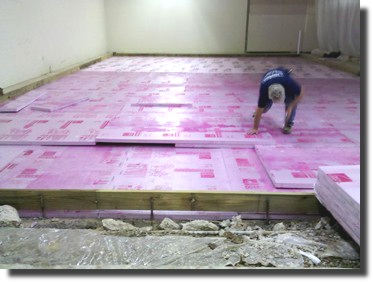 Applying insulation for a refrigerated room.