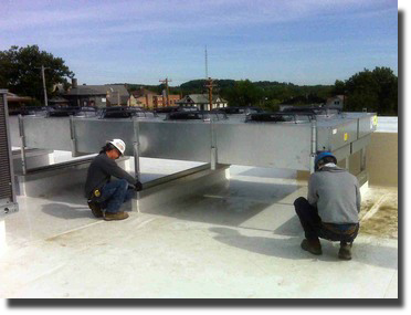 Our crew installing ducting on a roof.